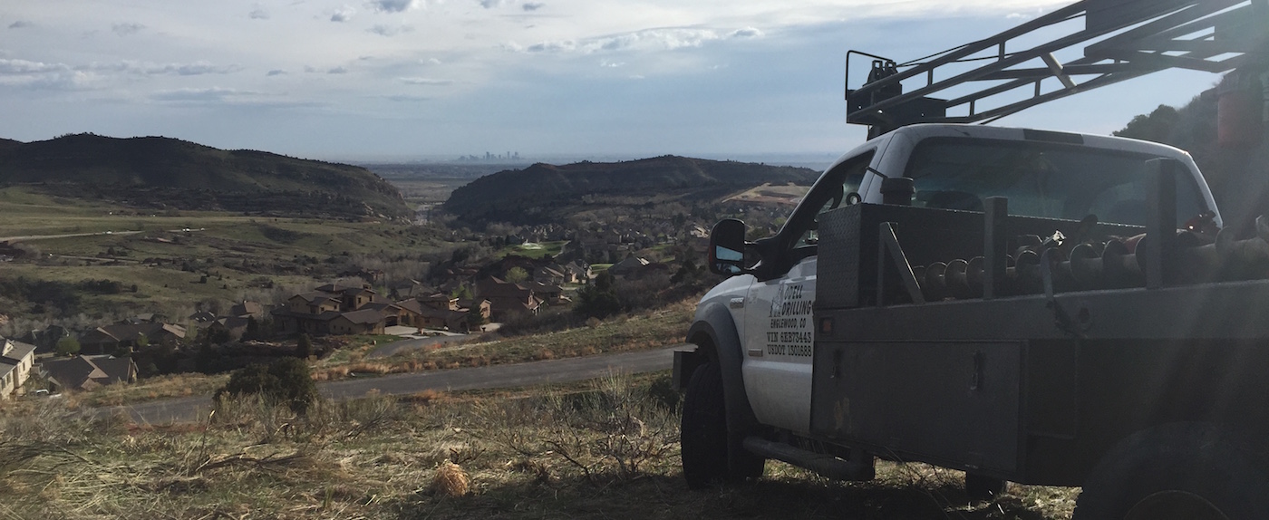 small drill rig overlooking development