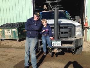 dad and son with drill rig